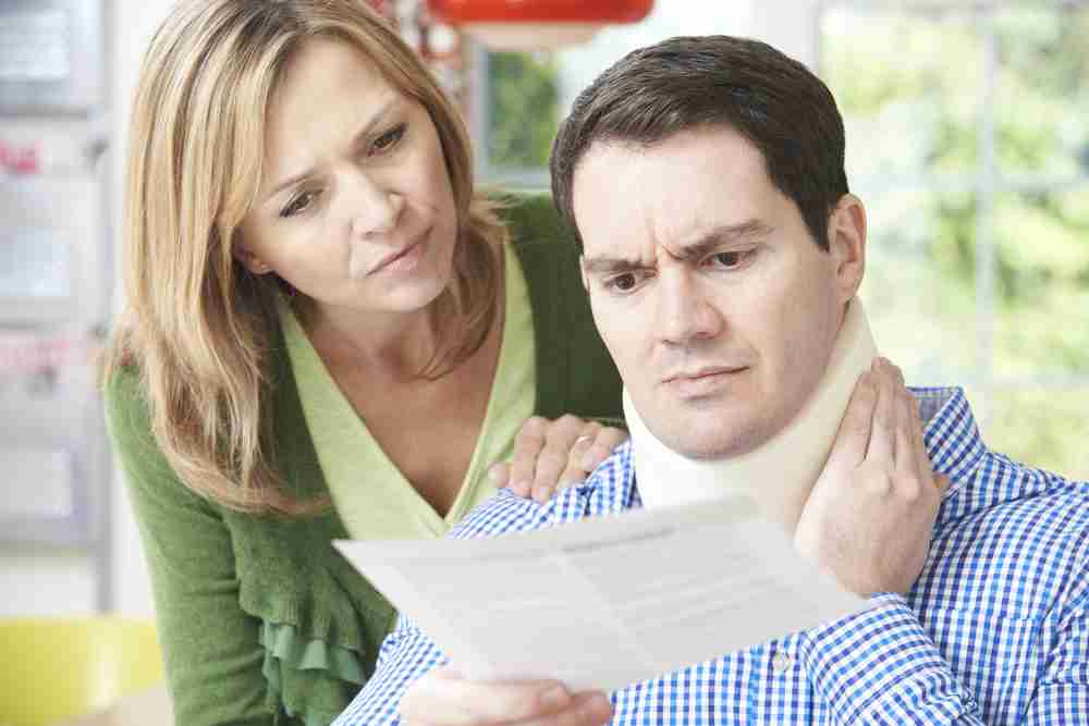 Person reviewing accident claim documents deciding whether to use a personal injury solicitor