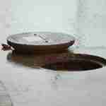Drain Manhole Cover Trip Claim Liability Defective manhole cover displaced above road surface leaving an open hole and serious trip hazard