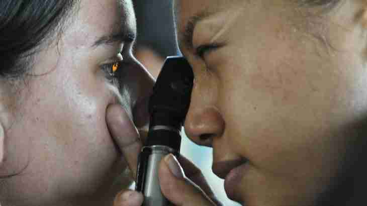 Eye specialist examining a patient’s eye injury with medical equipment