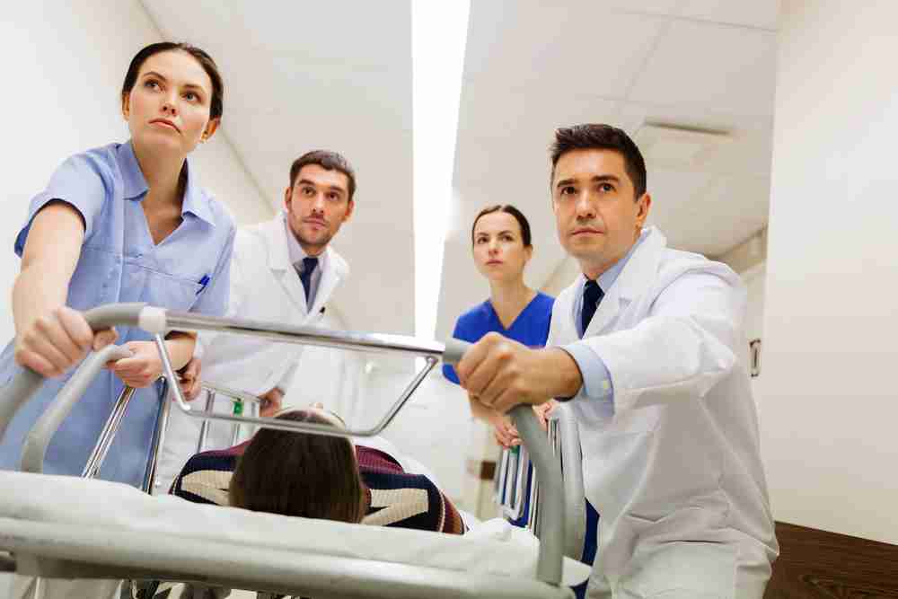 Patient on hospital trolley urgently being pushed by paramedics to get emergency treatment hospital negligence patient emergency