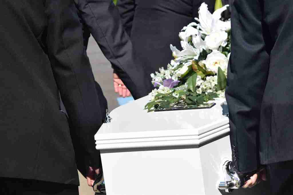 Family carrying coffin of deceased husband and father husband death compensation claim wife children