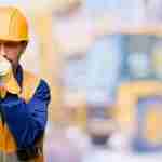 Lung Disease Claim Worker in protective gear coughing due to lung disease from workplace exposure