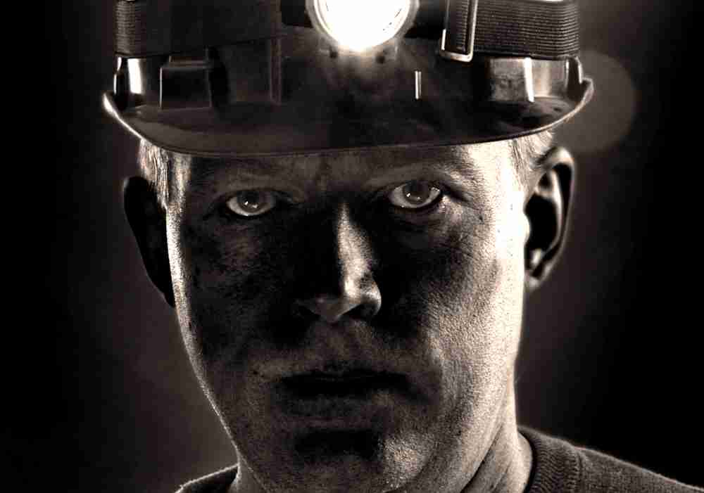 Miner covered in black dust with no breathing protection considering an occupational disease claim