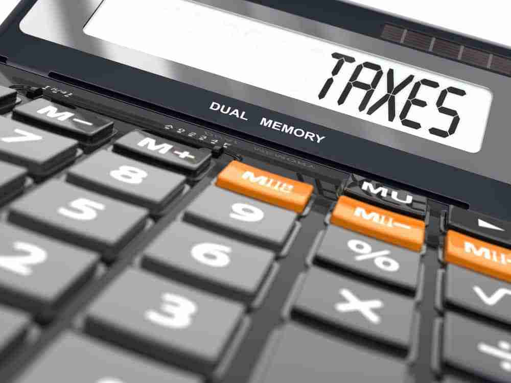 Calculator with the word taxes written on its screen personal injury compensation payments taxable